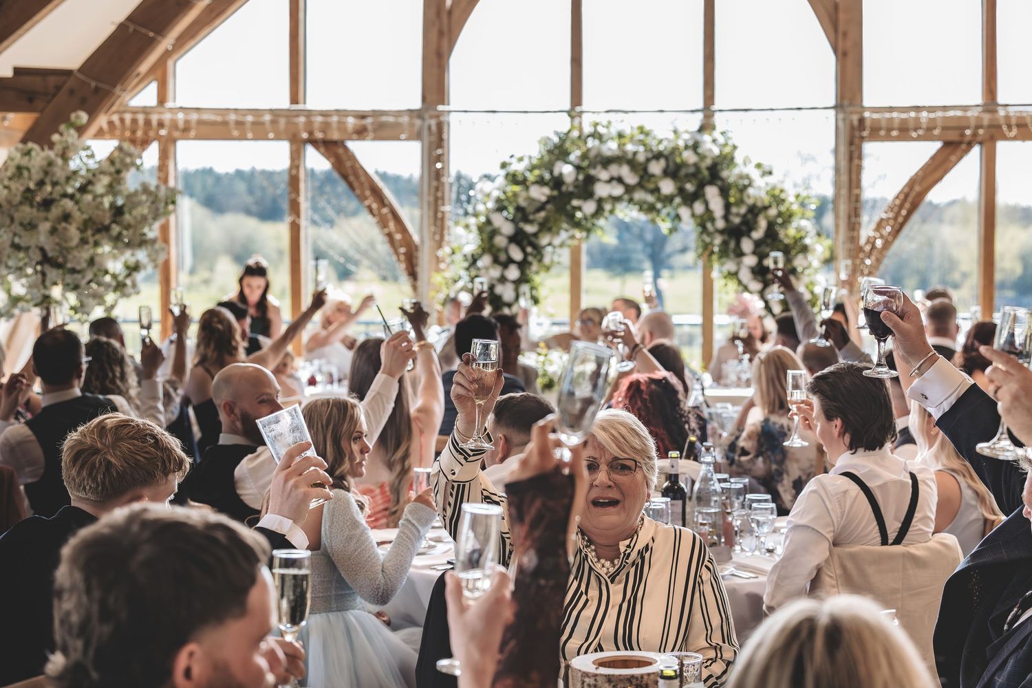Wedding guests enjoying drinks reception during speeches