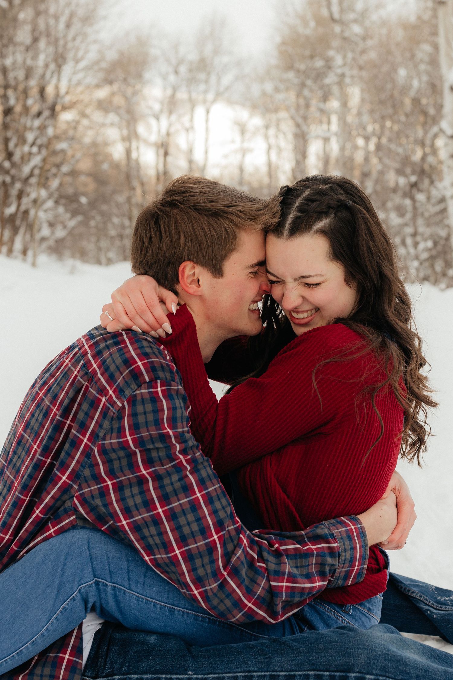 Engaged Couple Cuddling in Woods