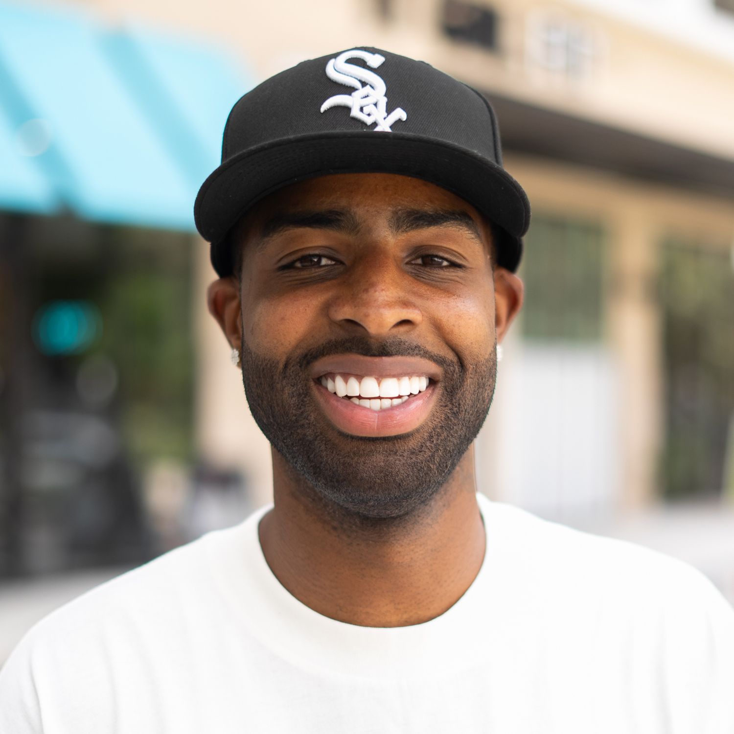 Orlando actor headshot photographer Ray Alvarez — casual male talent outdoor headshot with natural smile and street background