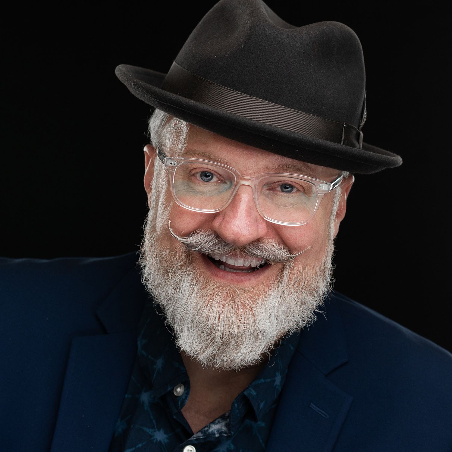 Orlando actor headshot photographer Ray Alvarez — distinguished male talent headshot with hat and white beard against dark background