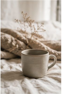 Rumpled linen bedding in soft beige tones, creating a cozy and relaxed bedroom aesthetic.