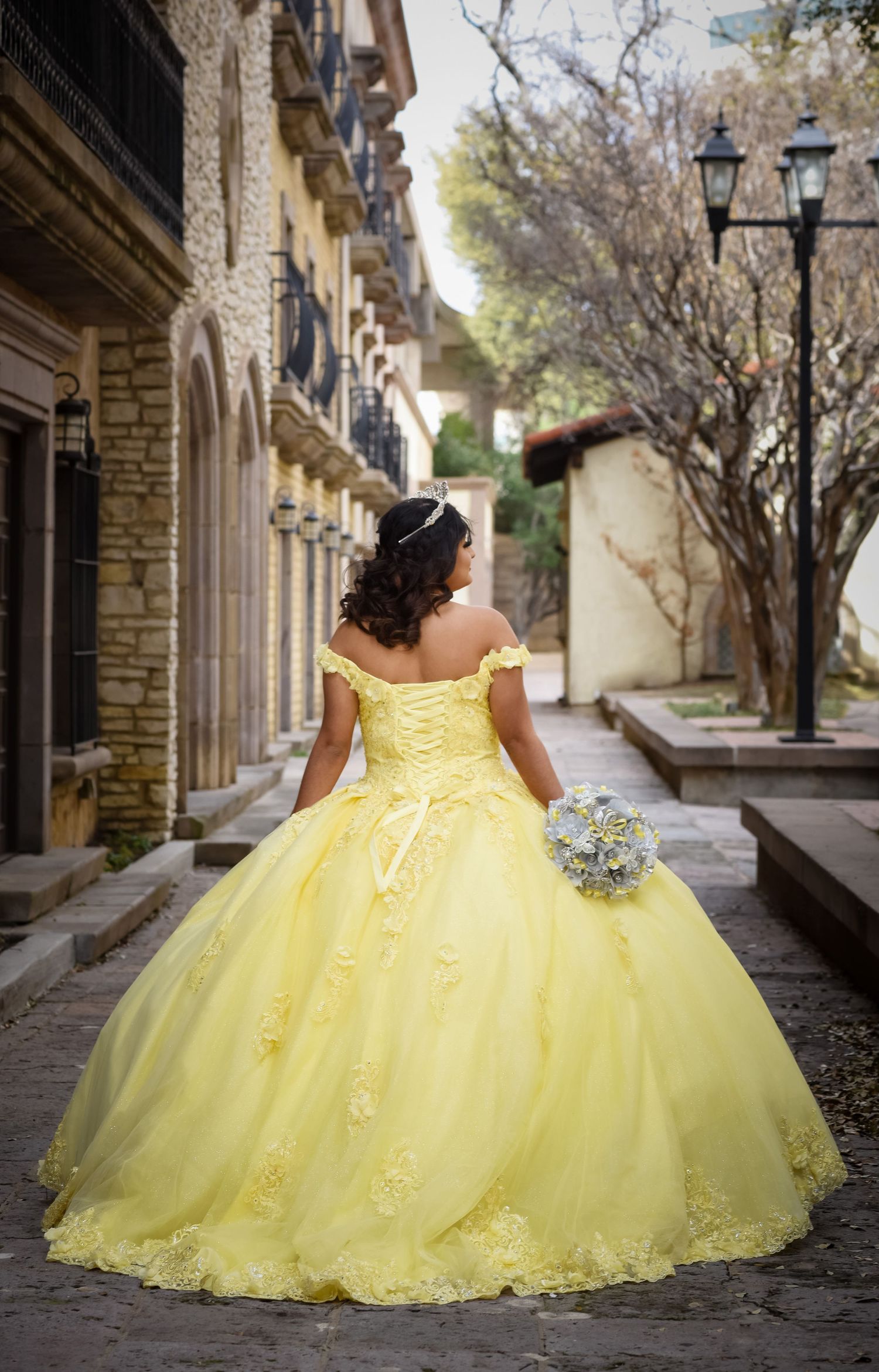 Luxury Quinceañera portrait session at Las Colinas Canals featuring Briana's elegant yellow Quinceañera dress and bouquet together.
