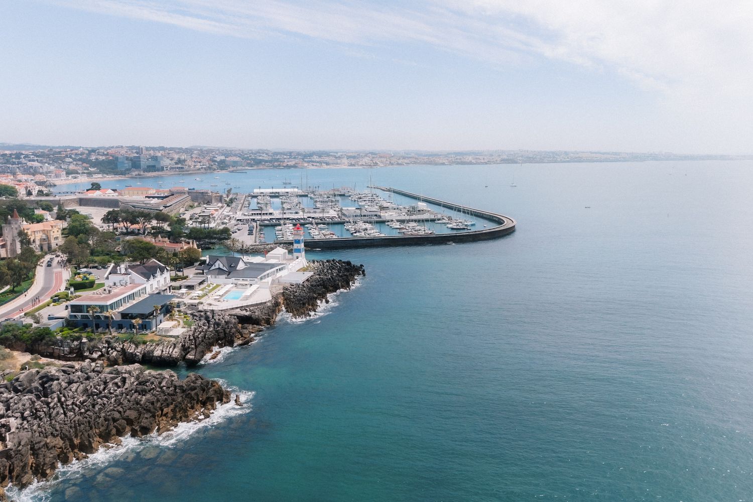 Aerial view of Farol Hotel in Cascais overlooking the Atlantic Ocean, where the bride and groom got ready before their destination wedding i