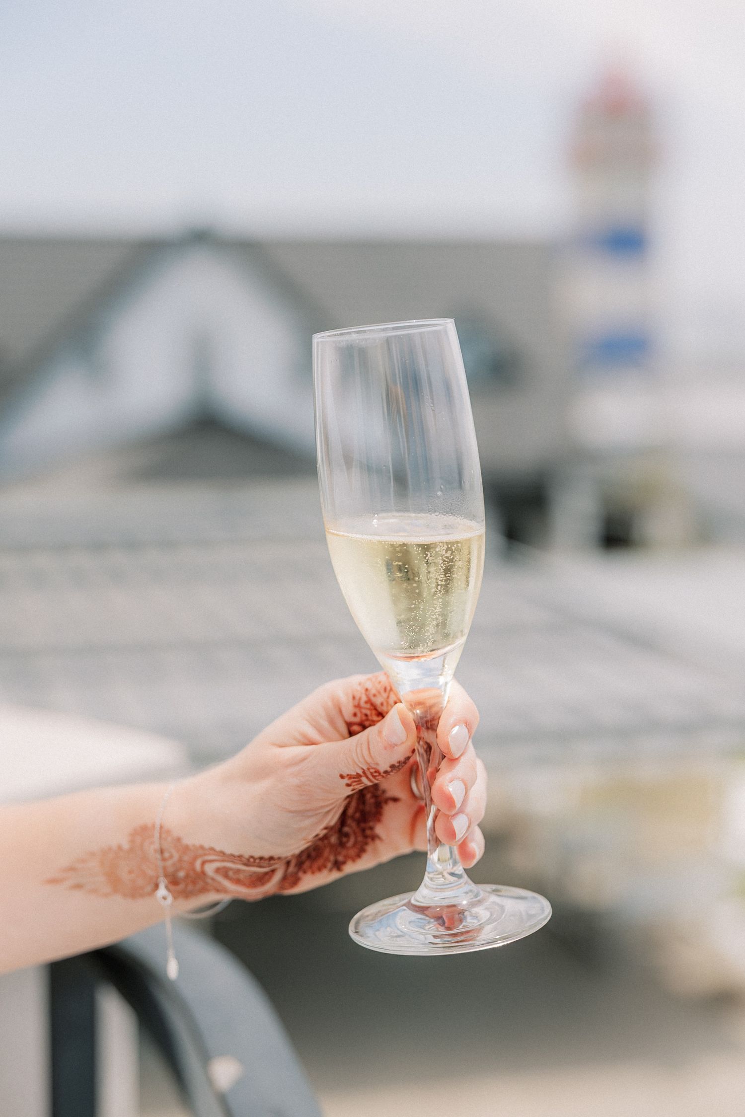Bride enjoying a champagne toast during wedding preparations at Farol Hotel in Cascais.