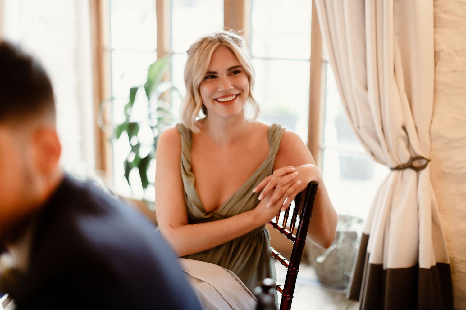 Guest enjoys a moment at an elegant indoor wedding reception.
