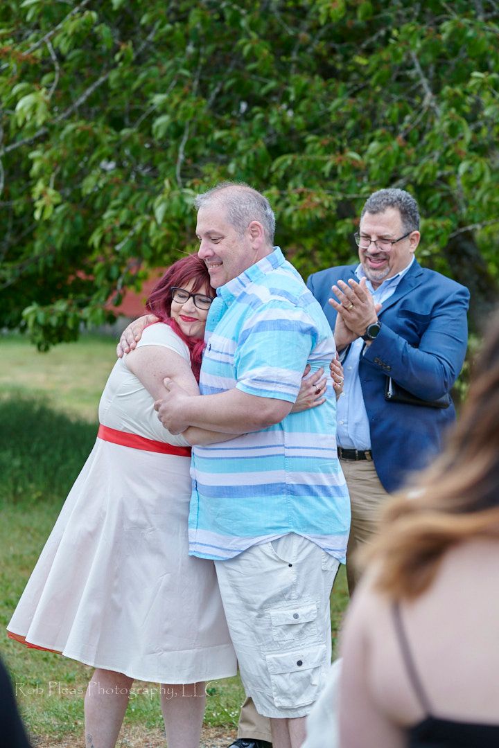 Wedding at Fort Steilacoom, Lakewood, WA, in May.  Just married bride and groom hugging first time as husband and wife.