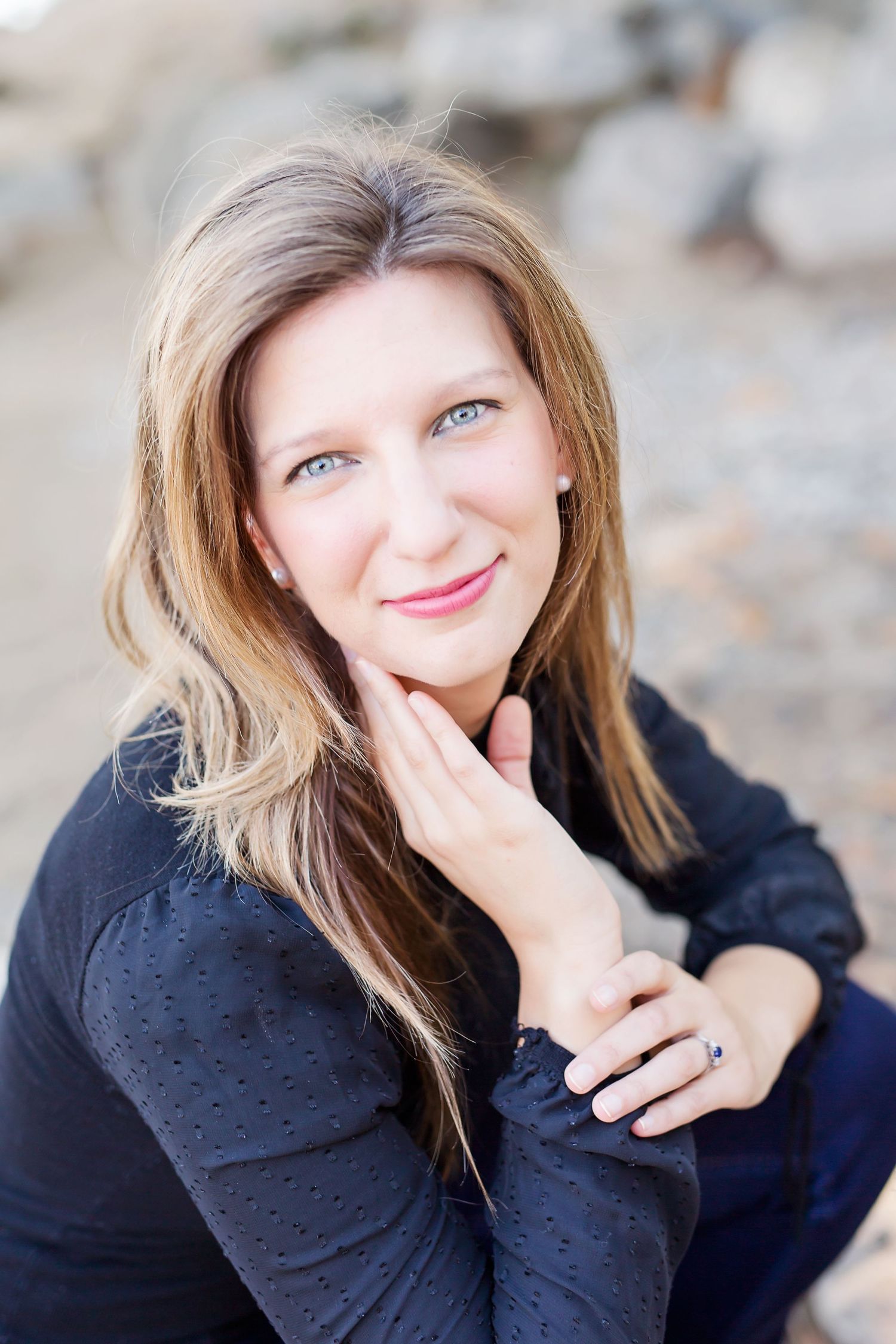 Close up portrait of woman in black sweater with soft natural lighting.
