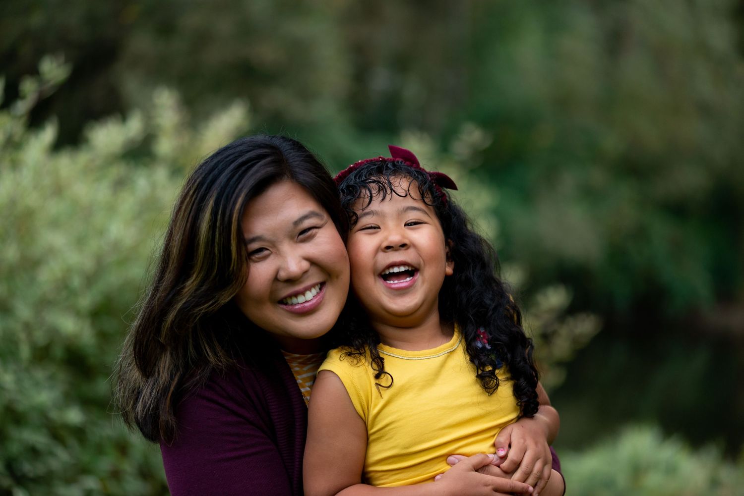 Family portrait session showing joyful laughter and embraces in outdoor setting.