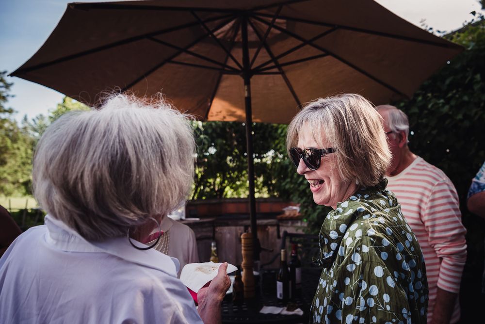 Colour image of two mature women laughing together.