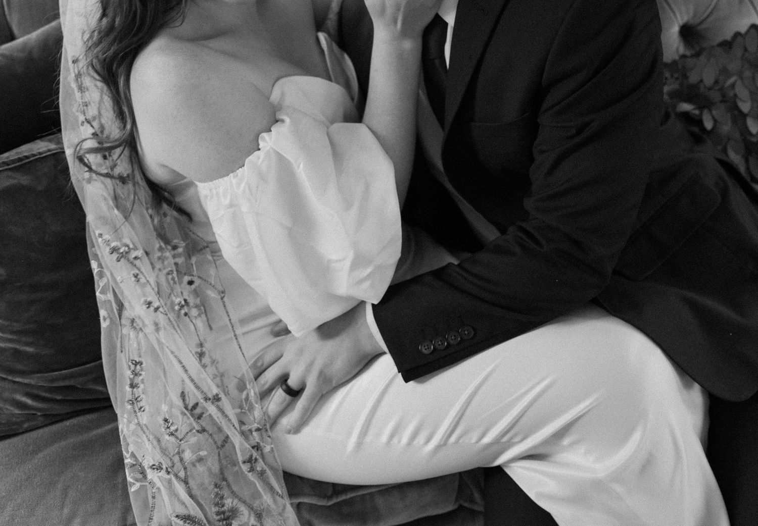 Black and white intimate portrait of couple in formal attire.
