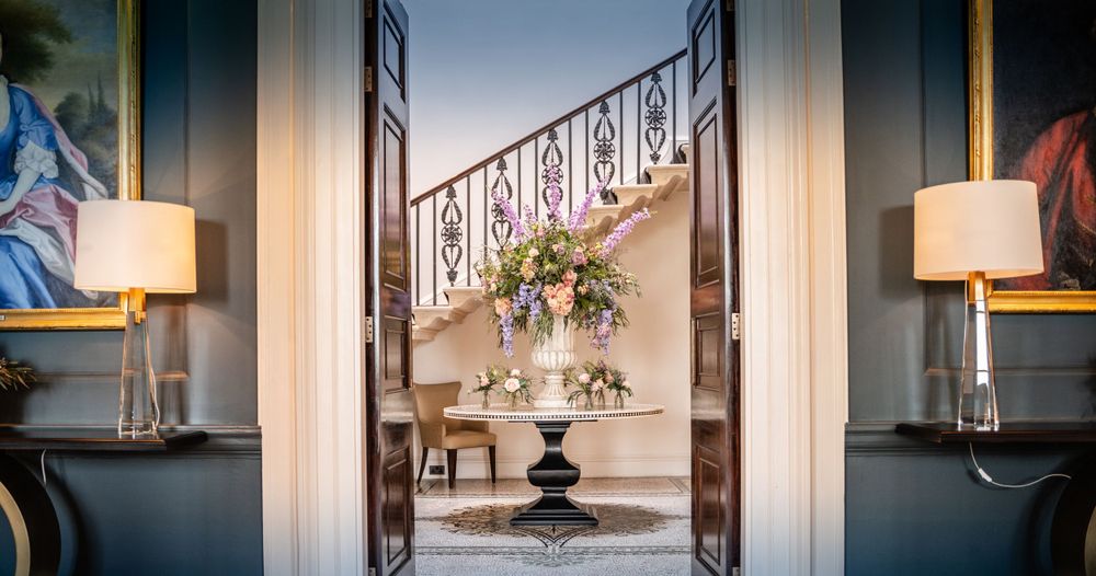 Modern interior doorway with black metal railings and natural light streaming through windows.