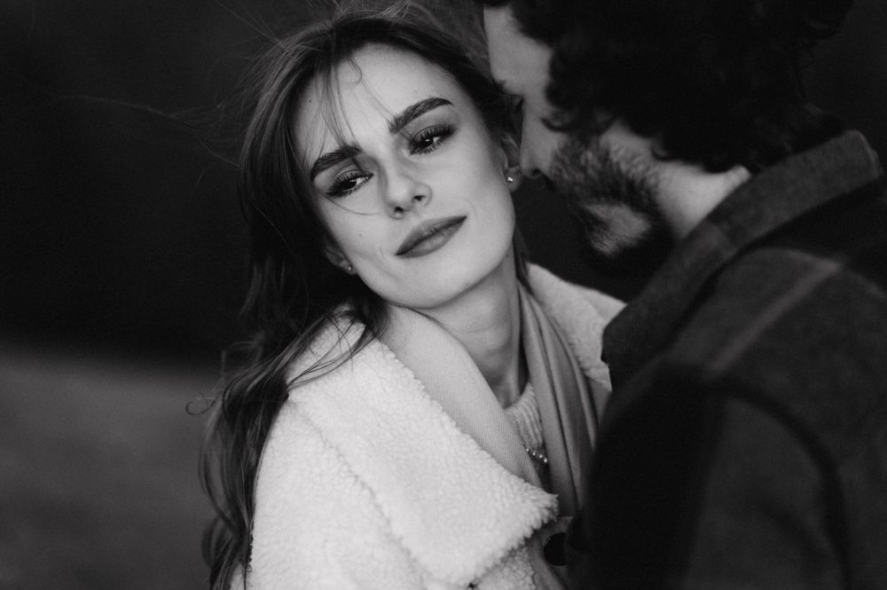 A black and white portrait capturing an intimate moment in the mountains.