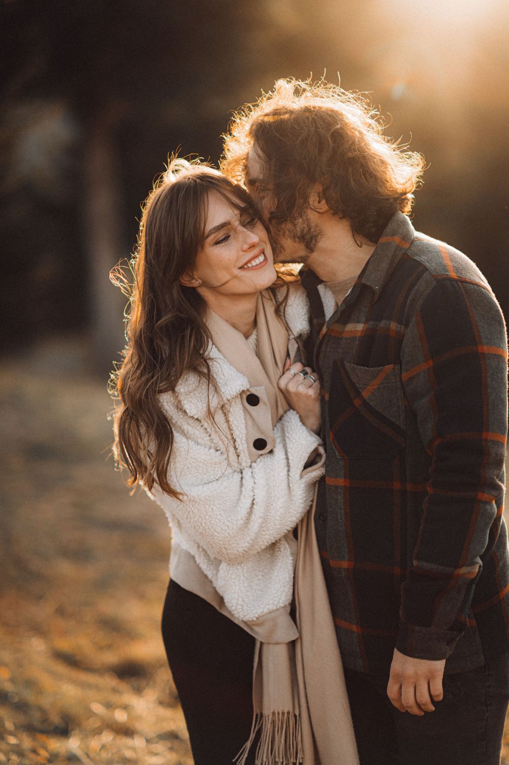Candid winter portrait with warm sunset backlighting and cozy winter attire.