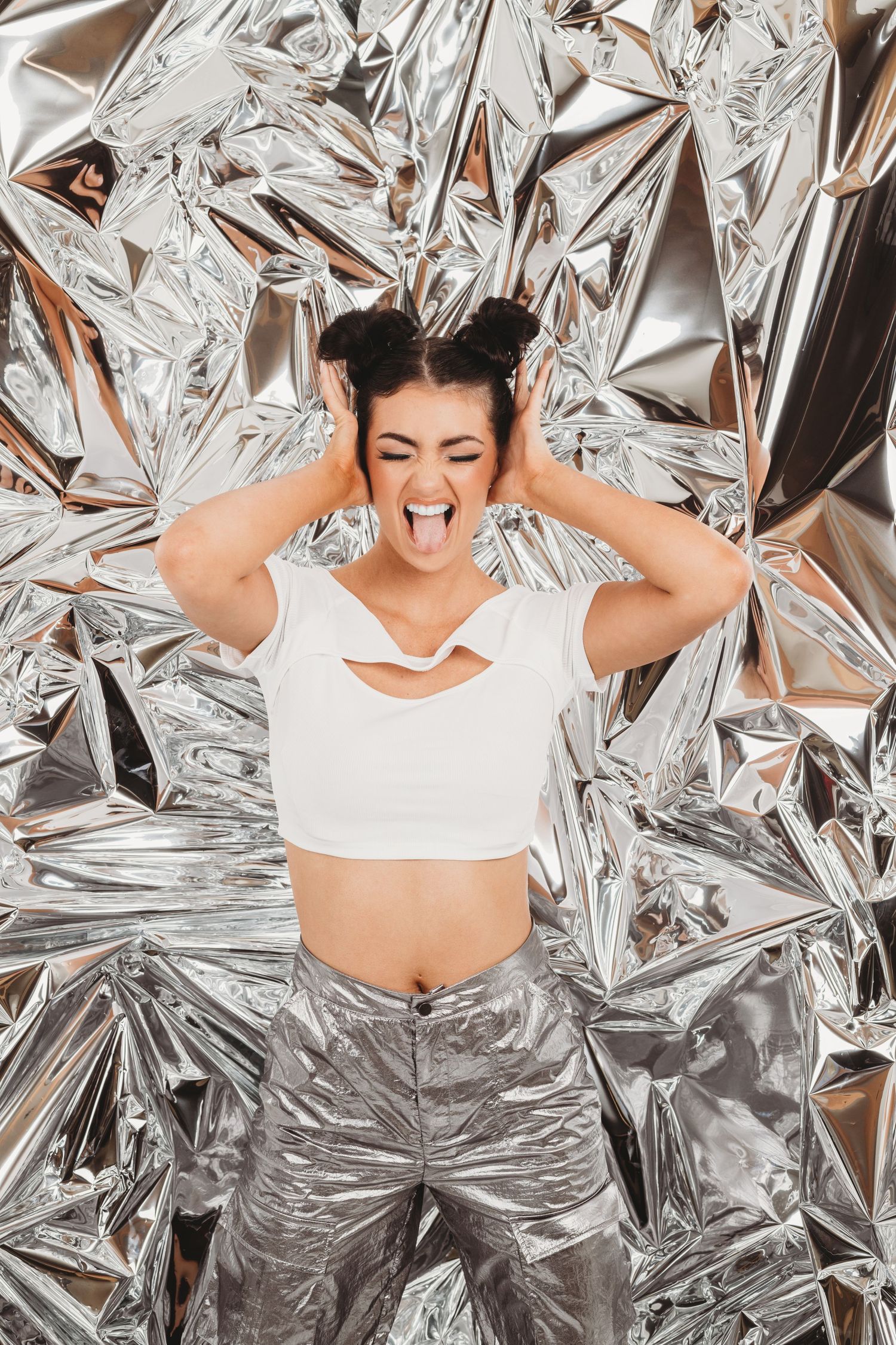 Dynamic poses against metallic silver backdrop wearing white athletic wear.