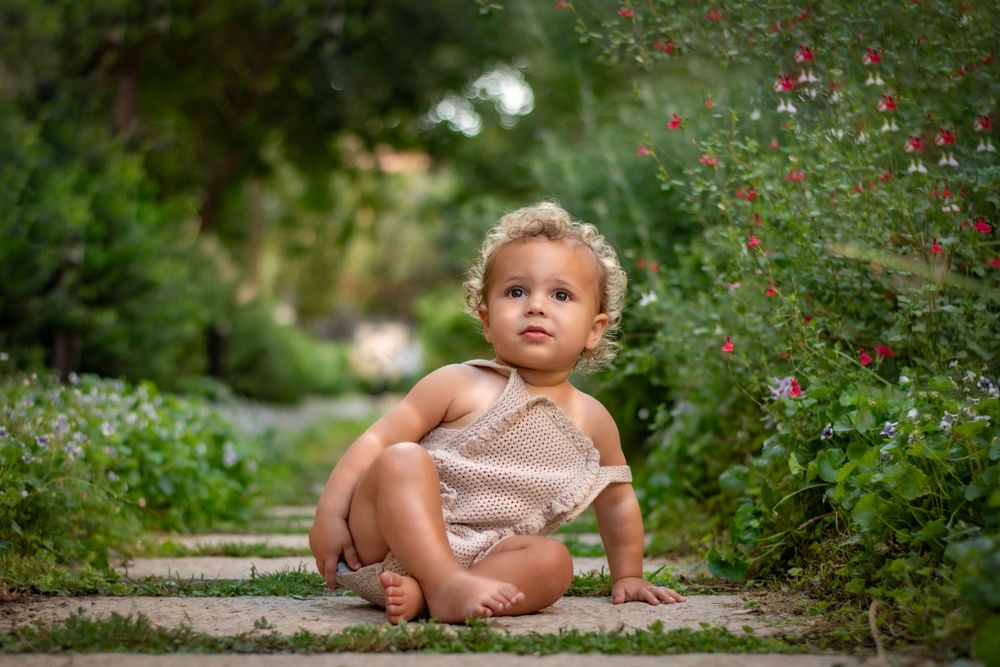 A toddler dreaming  in jerusalem Estates garden, Jerusalem, during the summer season.