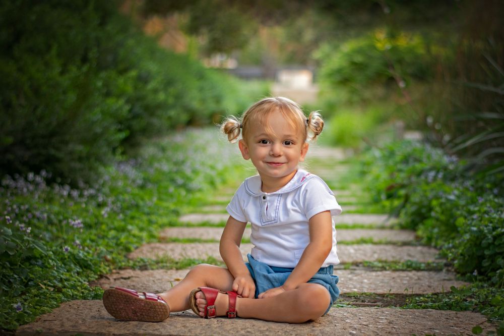 A young boy in the magical Jerusalem Estates garden, Jerusalem, Israel