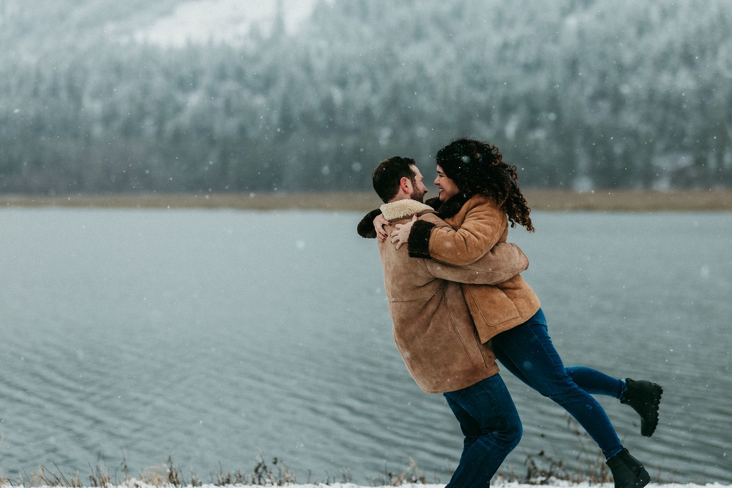 Couple dancing by a wintry lake