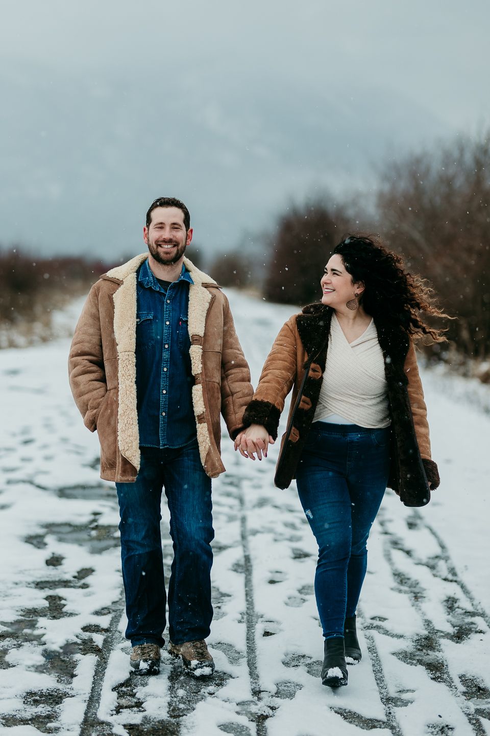 Couple walking hand in hand in the snow