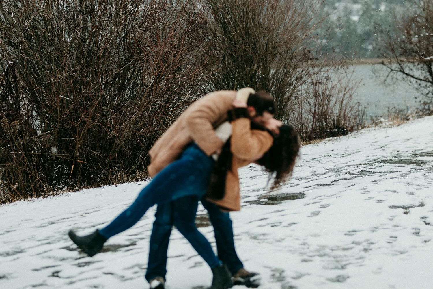 Couple sharing a romantic kiss in the snow