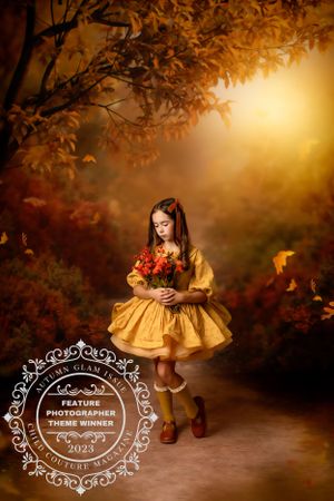 Autumn themed portrait in a golden dress holding flowers with warm sunset lighting.