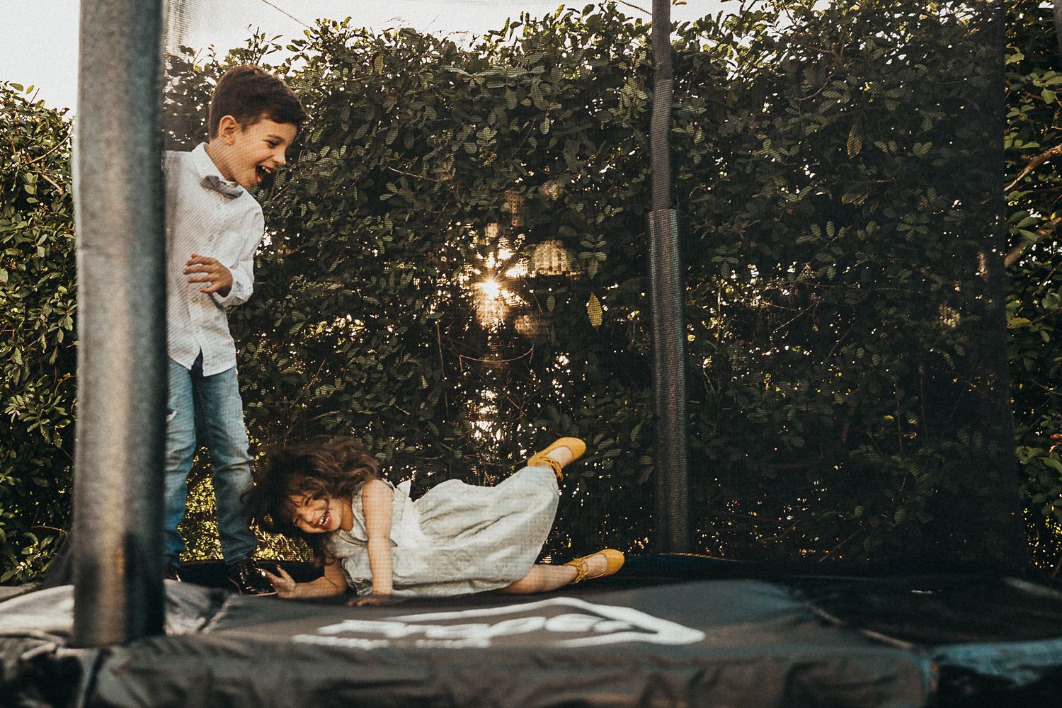 brother and sister playing on a bouncy house