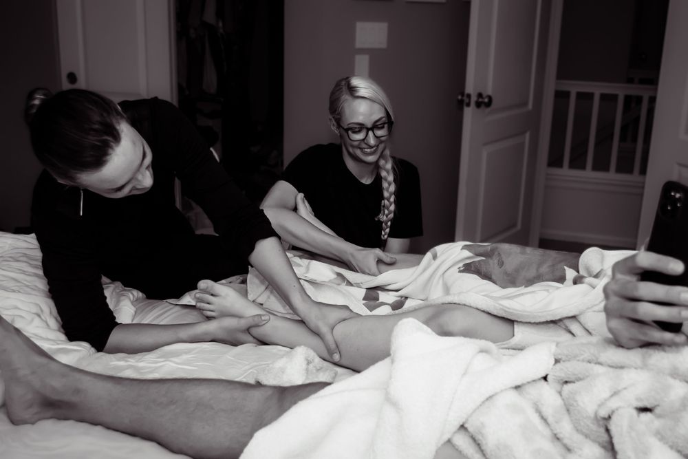 birth doulas provide relief to mother just after birth by massaging her legs and ankles while she rests.