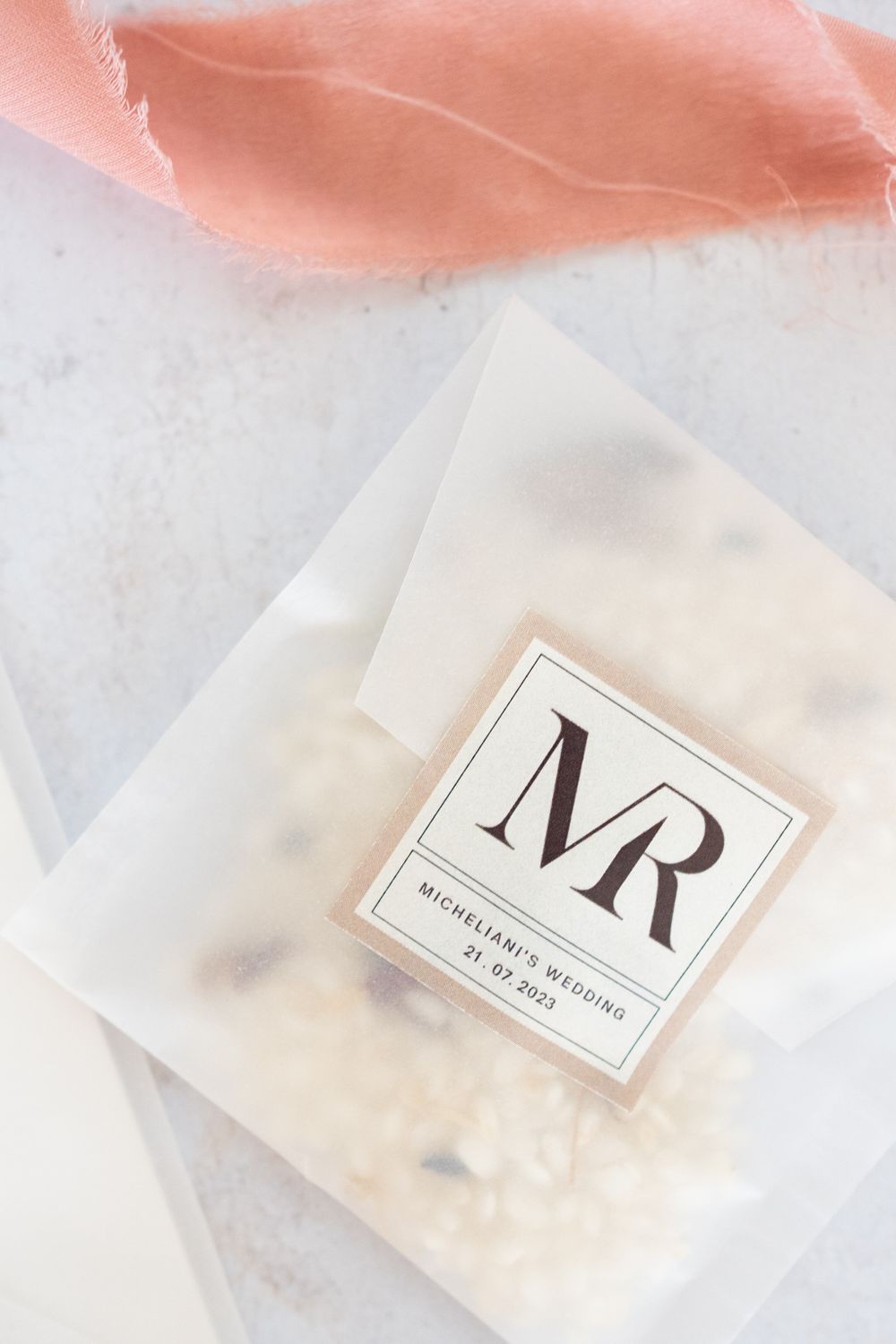 Wedding branding materials with MR monogram and coral silk ribbon details.