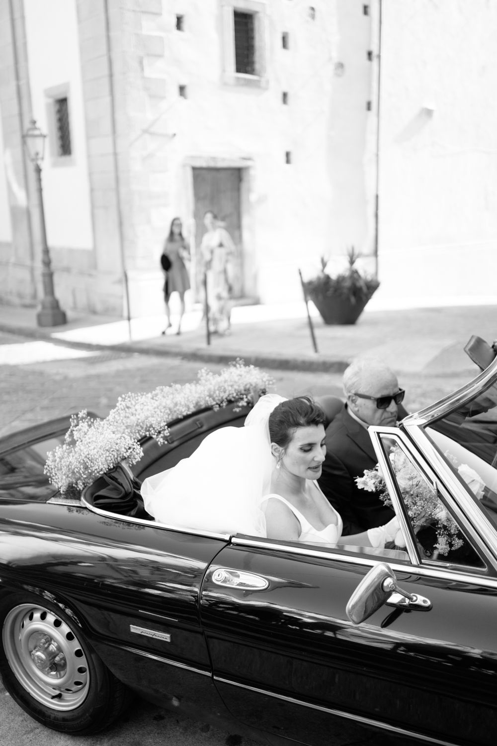Classic black vintage convertible car captured in black and white photography.