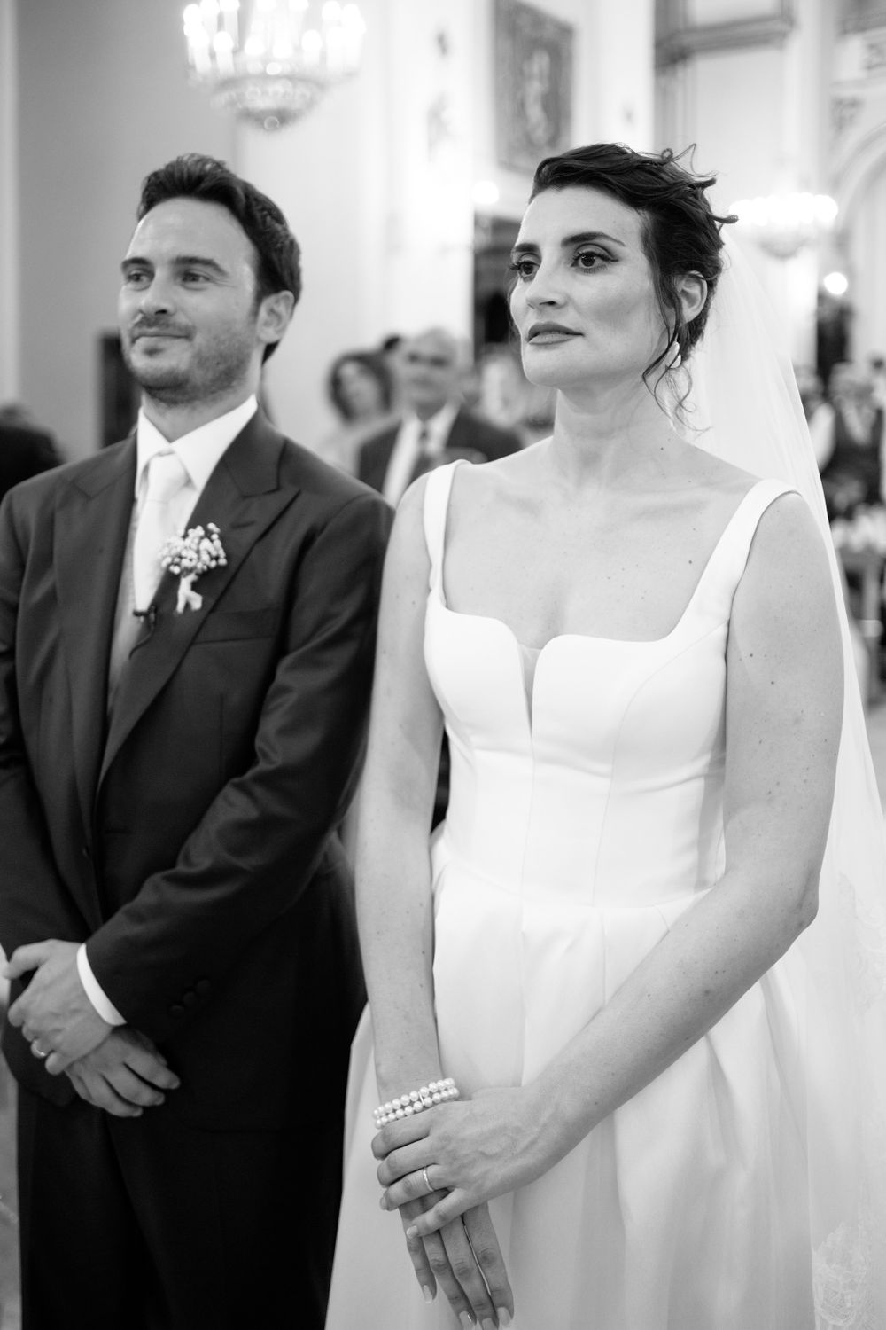 Wedding ceremony candids showing a couple in formal attire standing at the altar.