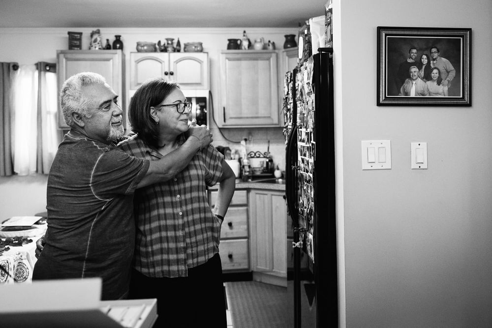 Parents of the groom watch the bride getting ready in their Nassau County Long Island home.