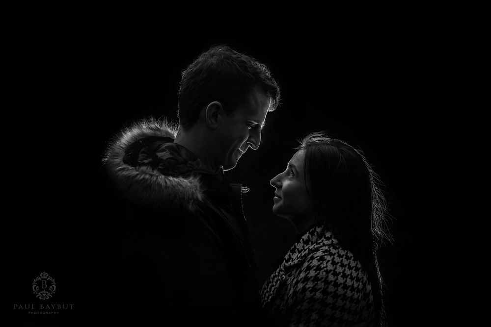 Newly engaged couple stare into each others eyes in total darkness during their Manchester engagement photography shoot