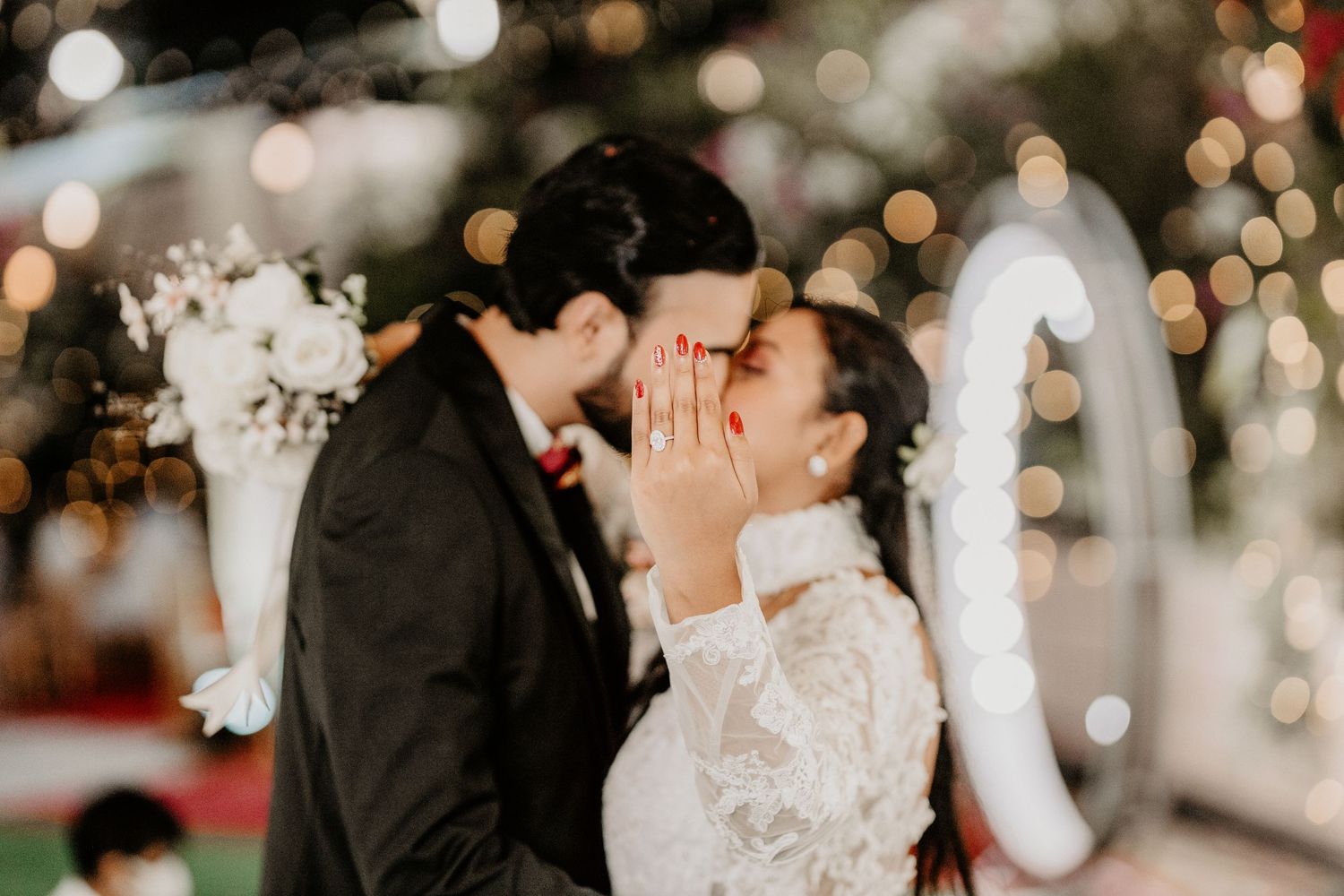 Romantic dance sequence with soft bokeh lighting and floral decor.