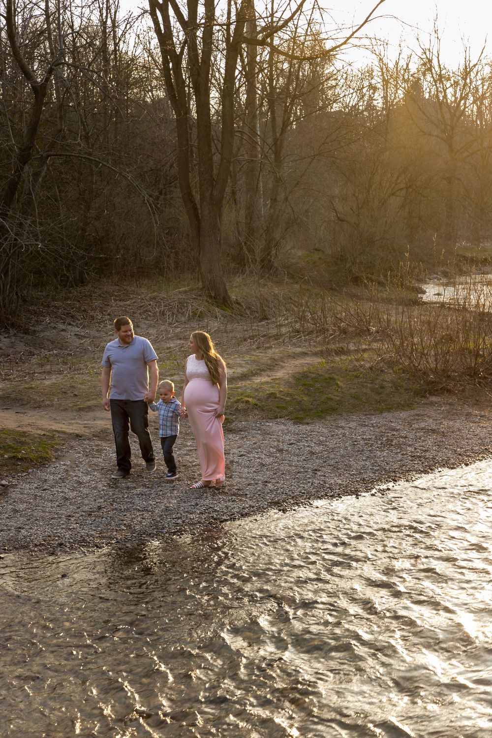 Family photo near a creek at sunset.