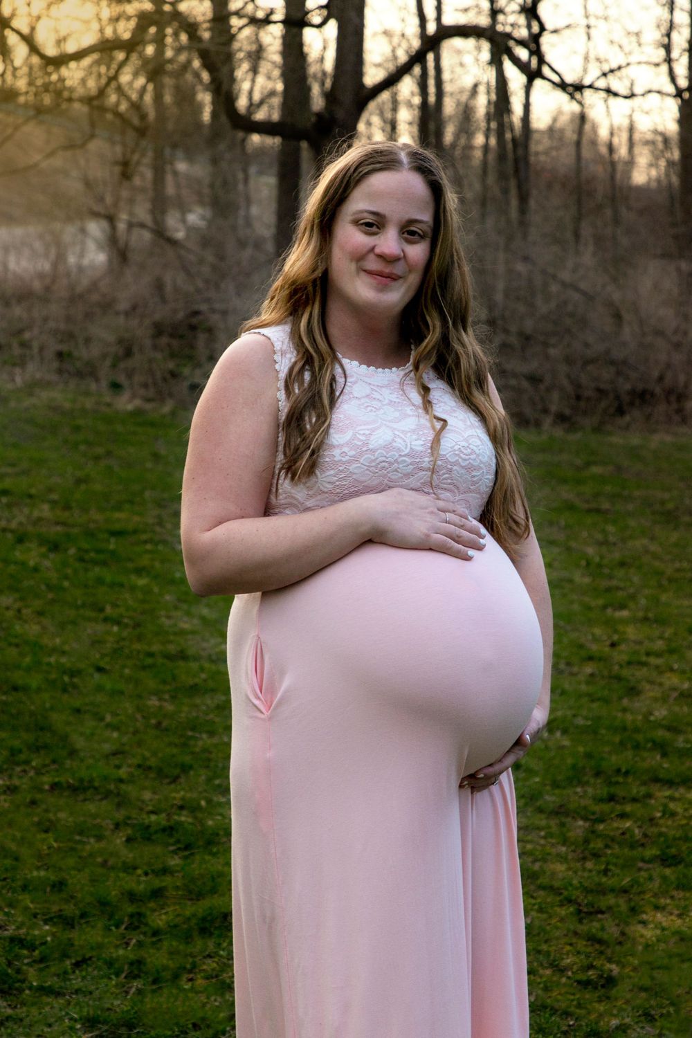 A maternity shoot at the bowmanville creek. Mom is pregnant with Twins, wearing a pink dress.