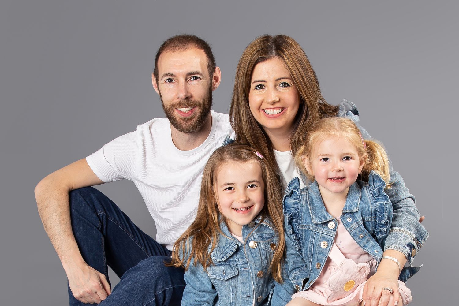 mum and dad with 2 girls in denim jackets