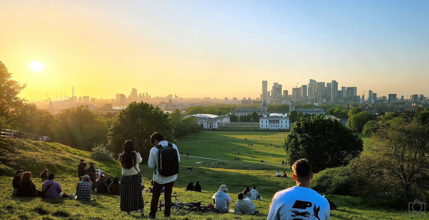 Crowd gathering on the Royal Observatory lawn at sunset
