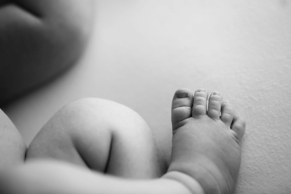 Black and white image of newborn baby's toes.