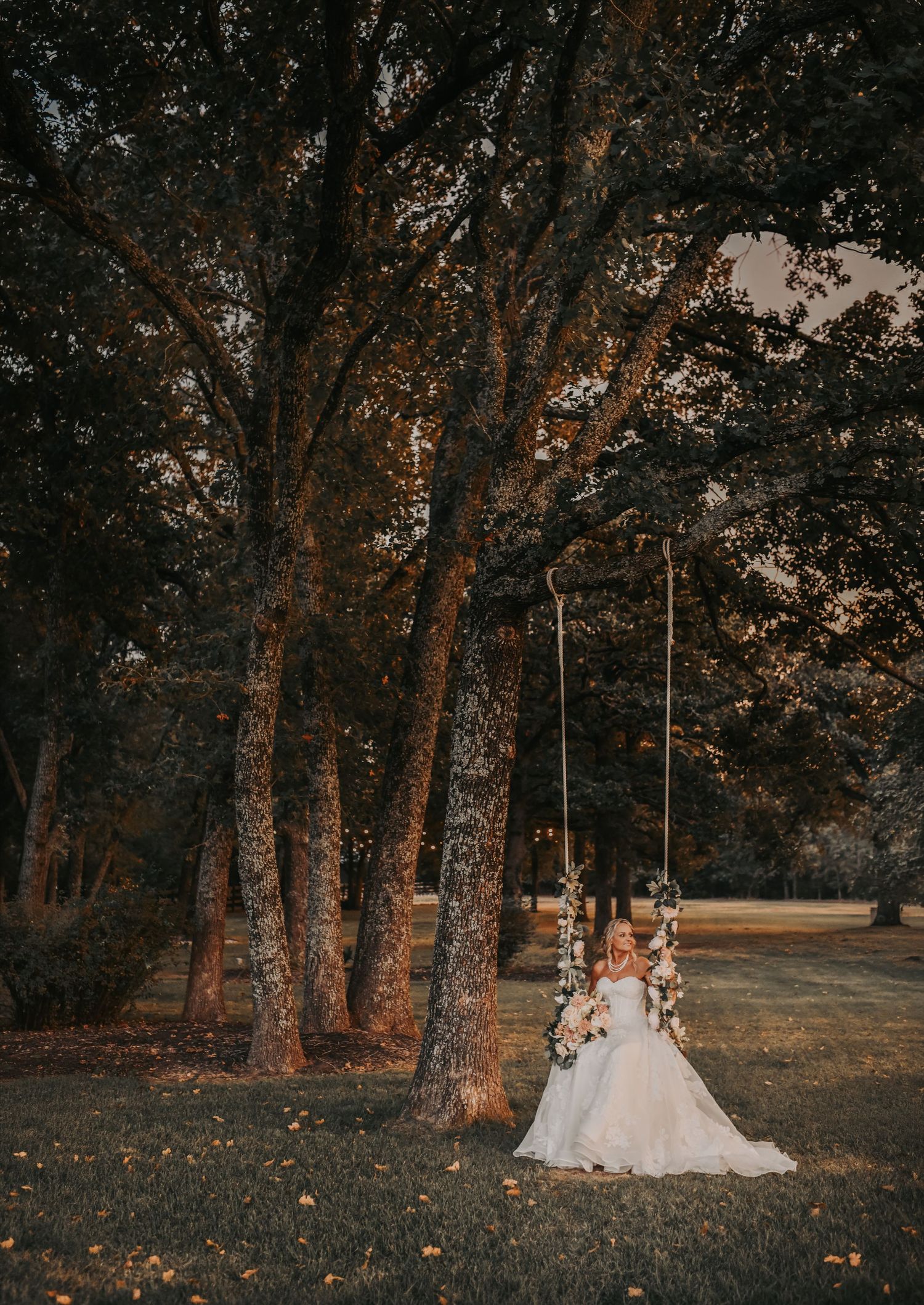 the bride at sunset on the bridal swing at the white sparrow wedding venue