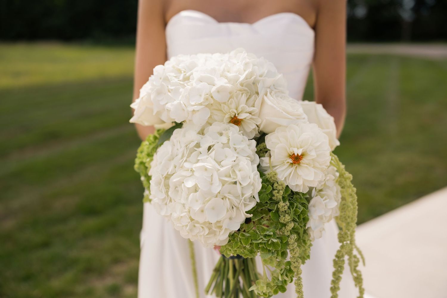 Close-up of bride's bouquet in front of white hydrangeas on the grounds of Tall Oaks Resort, Ohio