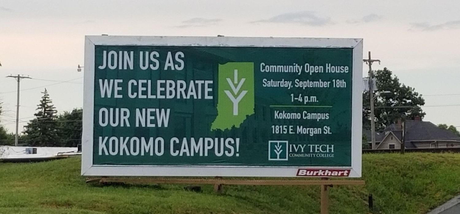 Outdoor billboard advertising Ivy Tech's Kokomo campus open house against a cloudy sky.