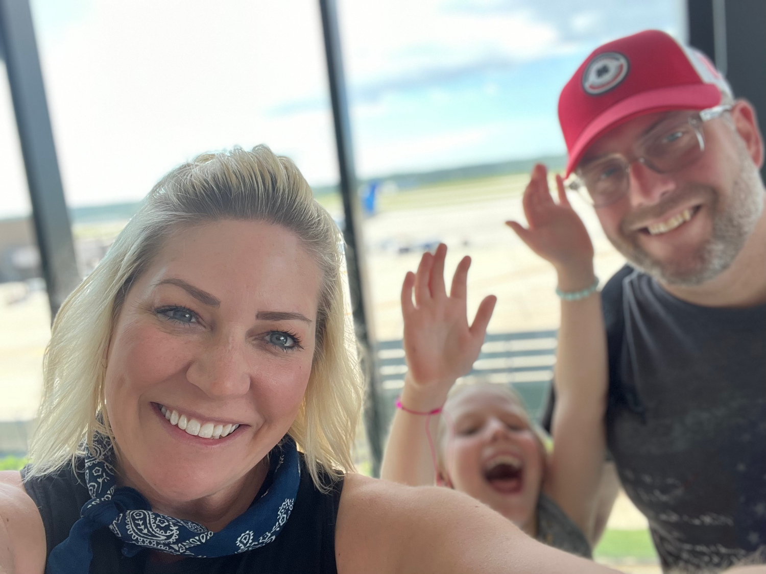 Group of friends taking a fun selfie together in a car.