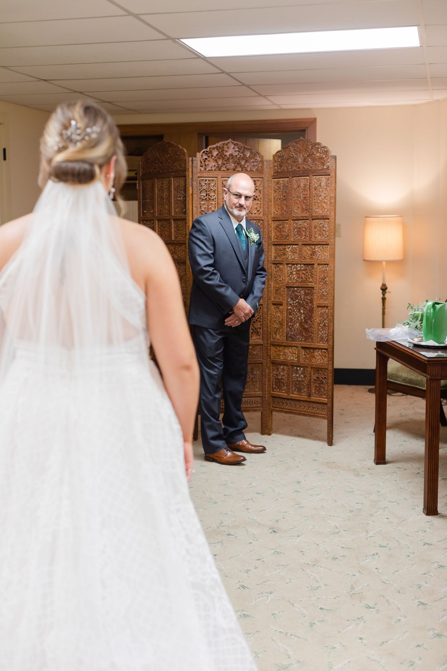 First look moment between bride and groom in an indoor venue.