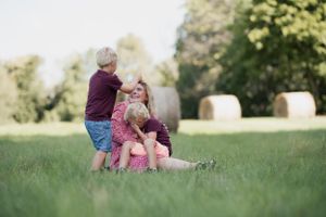 Joyful interaction on a sunny day with hay bales dotting the pastoral landscape.