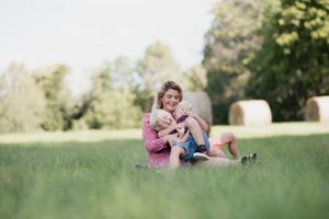 Gentle embrace captured in soft focus against a backdrop of summer greenery.