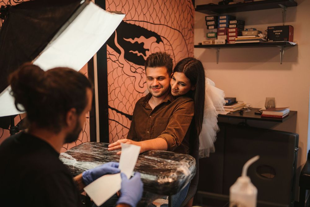 Behind-the-scenes photo shoot setup in a studio with warm lighting and decorative wall patterns.
