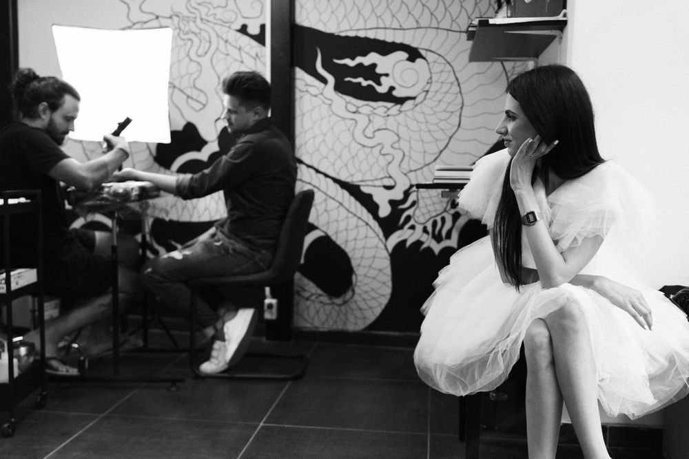 Black and white photo of studio shoot preparation with artistic wall decor.