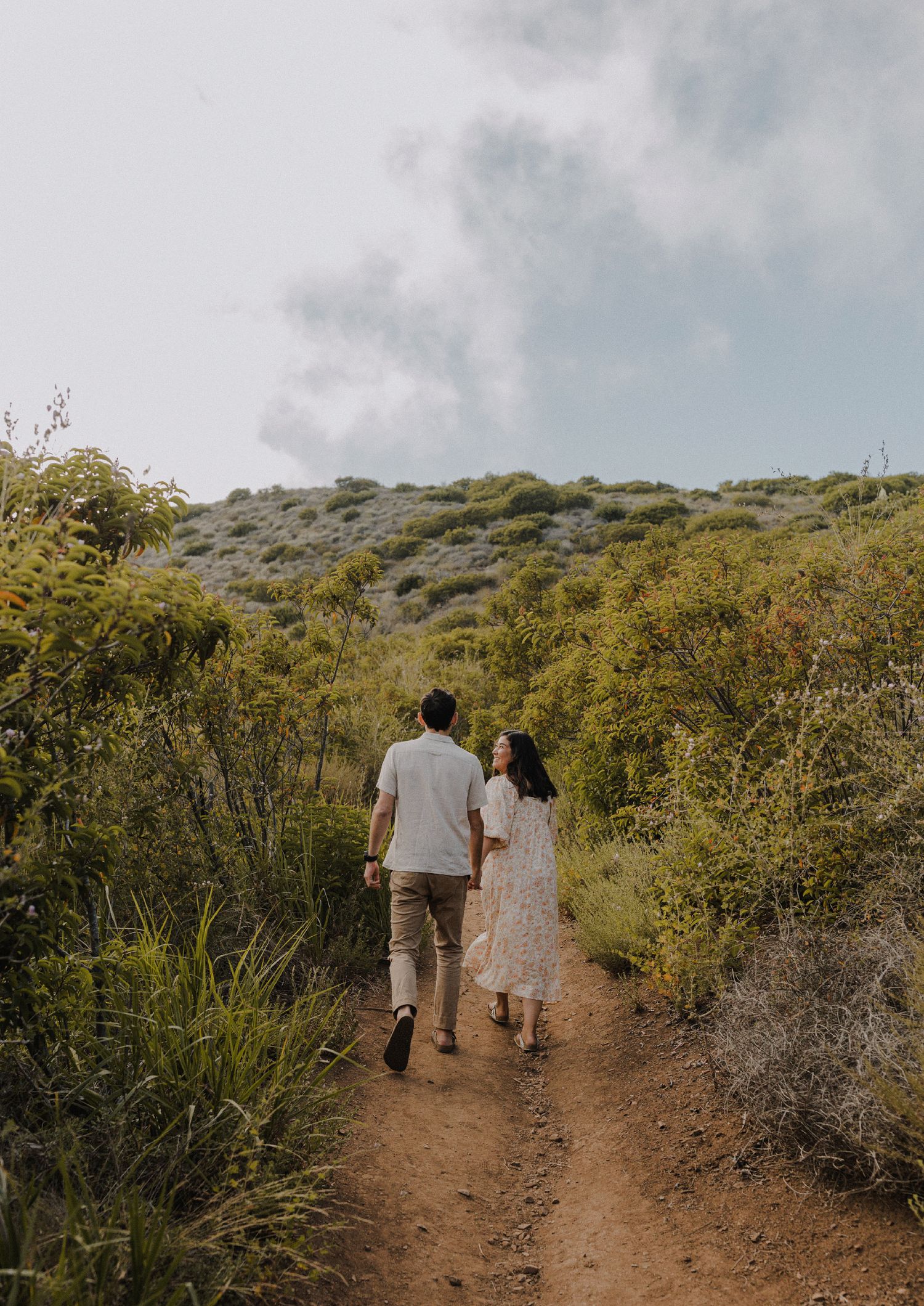 E. Noelle Photography couple engagement in the Los Angeles Malibu hills walking through trails from behind