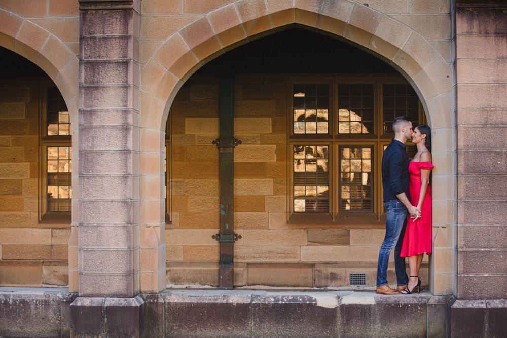 Stone colonnade with arched windows and architectural details at historic building.