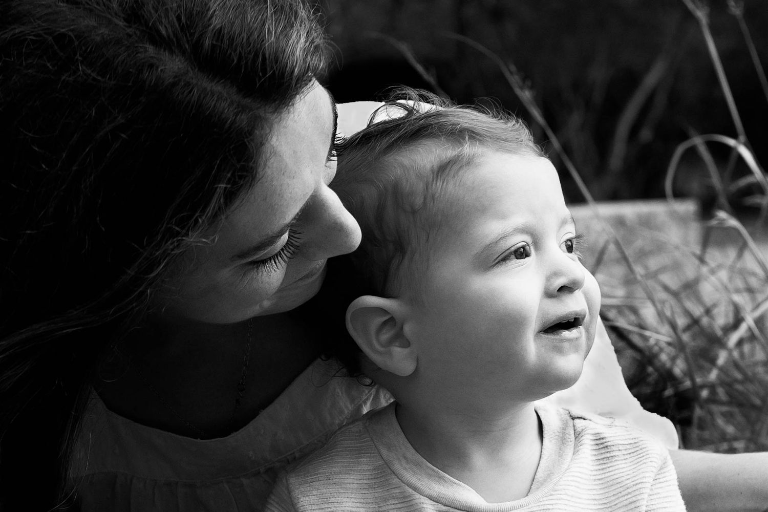 black and white image of mom holding toddler