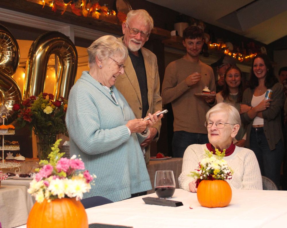 Celebration gathering with pumpkin centerpieces and festive autumn decorations.